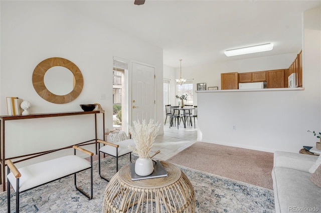 living room featuring light carpet and a notable chandelier