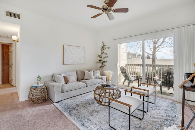 carpeted living room featuring visible vents and a ceiling fan