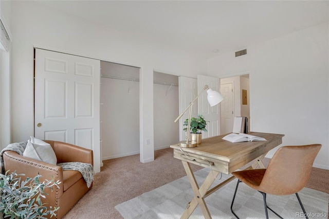 office area with light carpet, visible vents, and baseboards