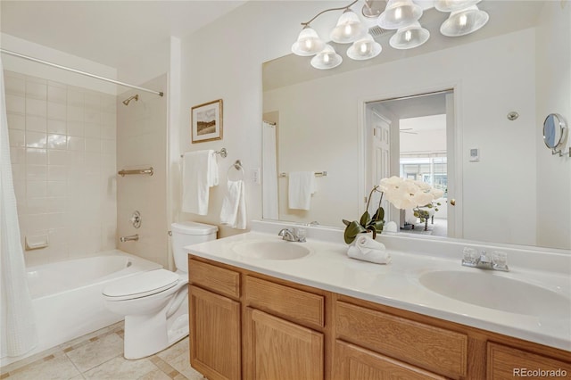 bathroom featuring double vanity, shower / washtub combination, a sink, and tile patterned floors