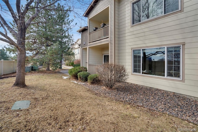 view of yard with fence and a balcony