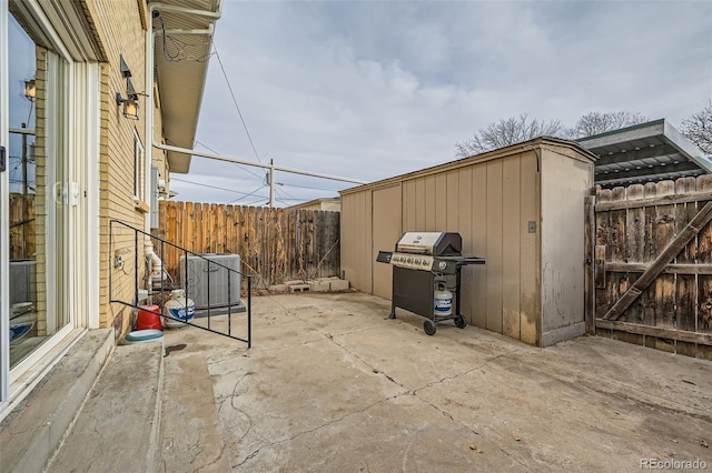 view of patio with cooling unit and a grill