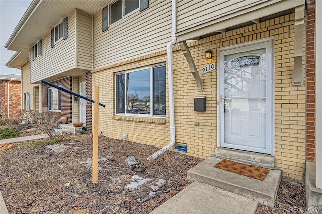 entrance to property with brick siding