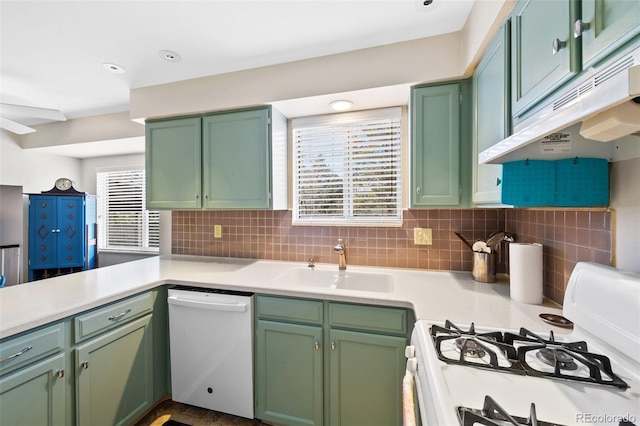 kitchen with white appliances, a healthy amount of sunlight, sink, and green cabinetry