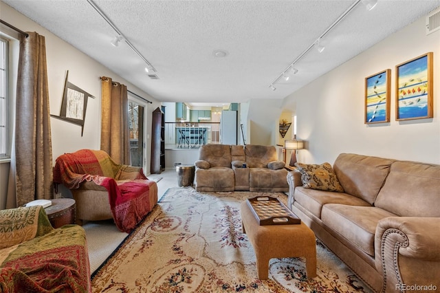 living room with track lighting and a textured ceiling