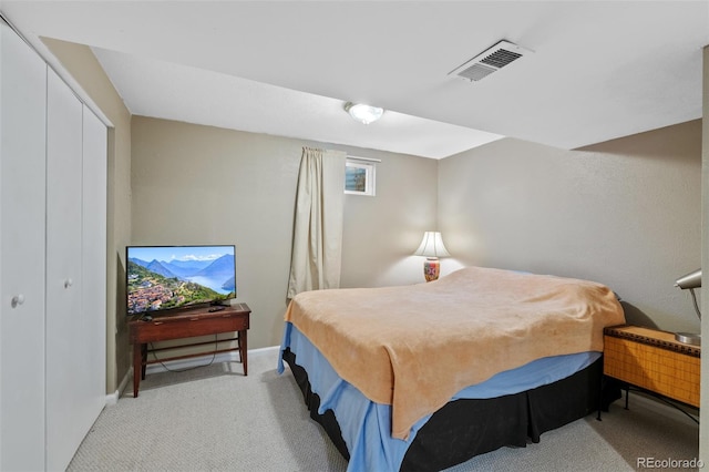 bedroom with light carpet and a closet