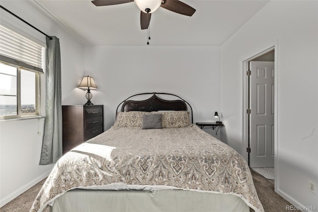 carpeted bedroom with ceiling fan and baseboards