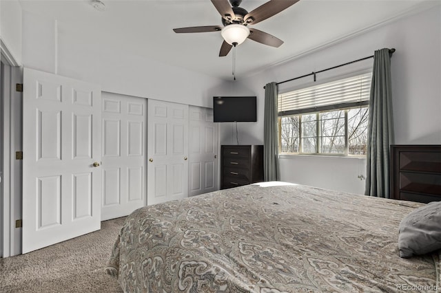 carpeted bedroom featuring a closet and ceiling fan