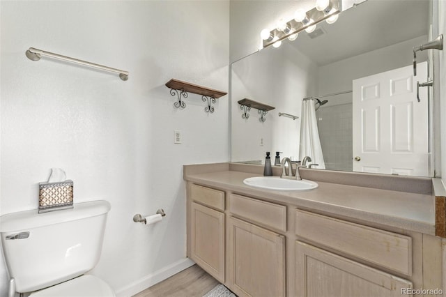 full bathroom with baseboards, toilet, a shower with curtain, wood finished floors, and vanity