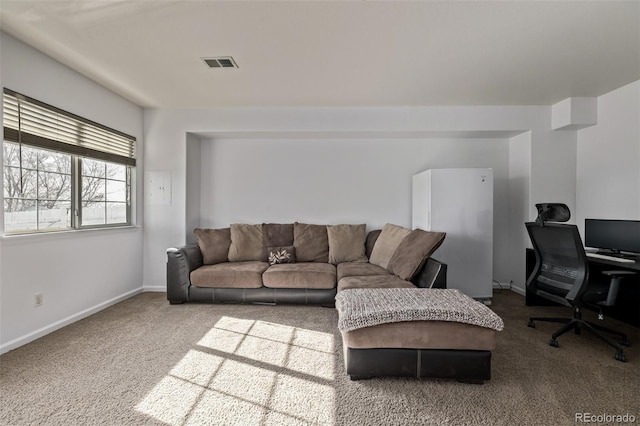 carpeted living room with visible vents and baseboards