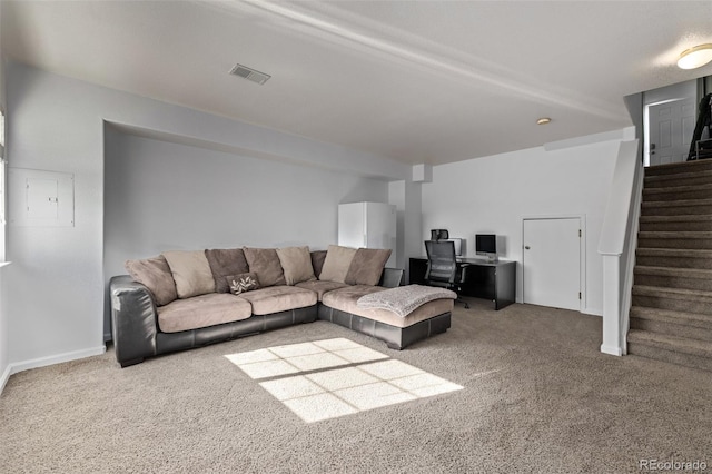 carpeted living room with stairs and visible vents