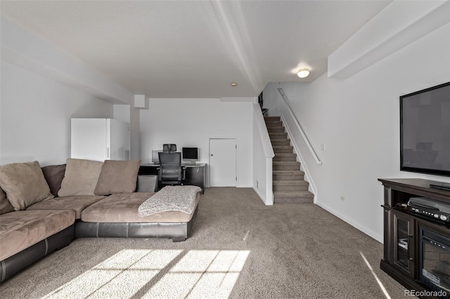 living area with stairway, baseboards, and carpet floors