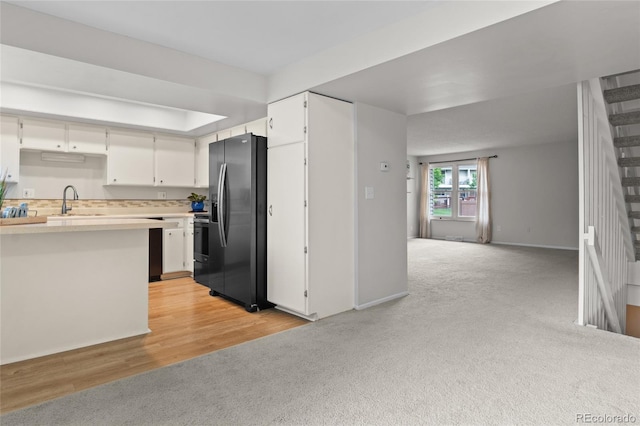 4262 E Maplewood Way, Centennial, CO 80121 - kitchen featuring stainless steel fridge, light carpet, light countertops, a sink, and white cabinetry