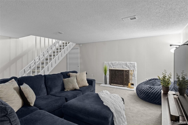4262 E Maplewood Way, Centennial, CO 80121 - carpeted living area with stairs and a textured ceiling