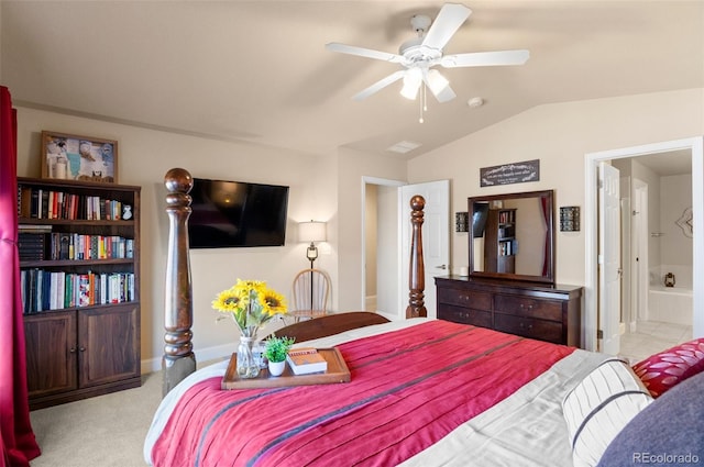 carpeted bedroom with connected bathroom, vaulted ceiling, and ceiling fan