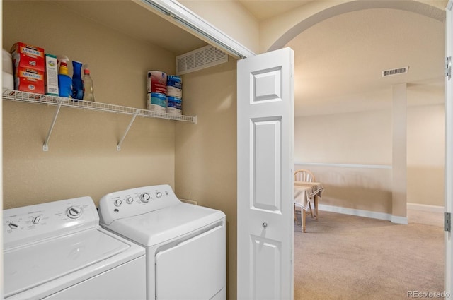 washroom with washer and clothes dryer and carpet