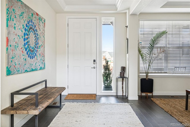 entrance foyer featuring dark hardwood / wood-style flooring, crown molding, and a healthy amount of sunlight