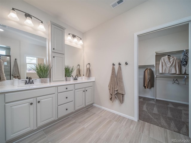 bathroom featuring vanity and an enclosed shower