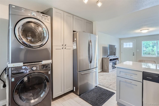 clothes washing area with stacked washer and dryer