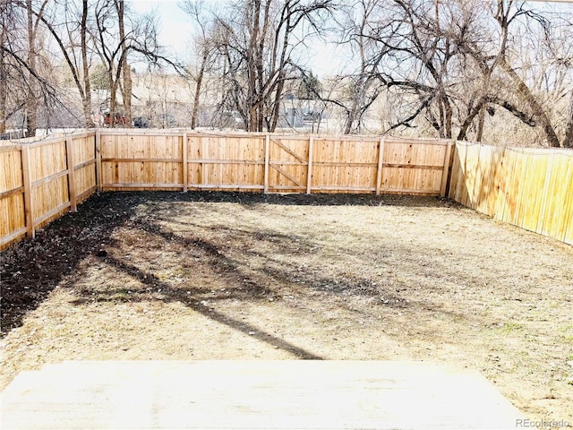 view of yard with a fenced backyard