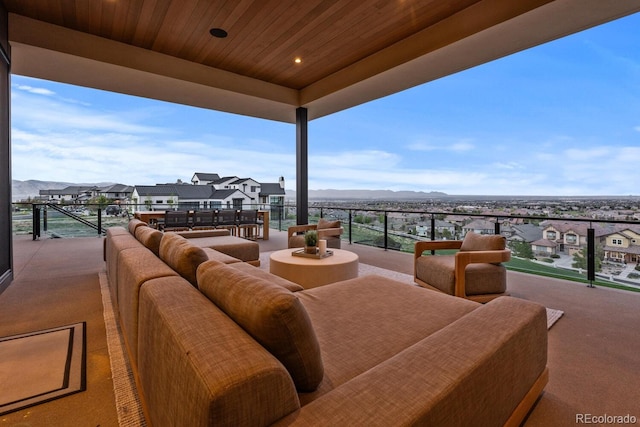 view of patio with an outdoor hangout area, a mountain view, a balcony, and a residential view