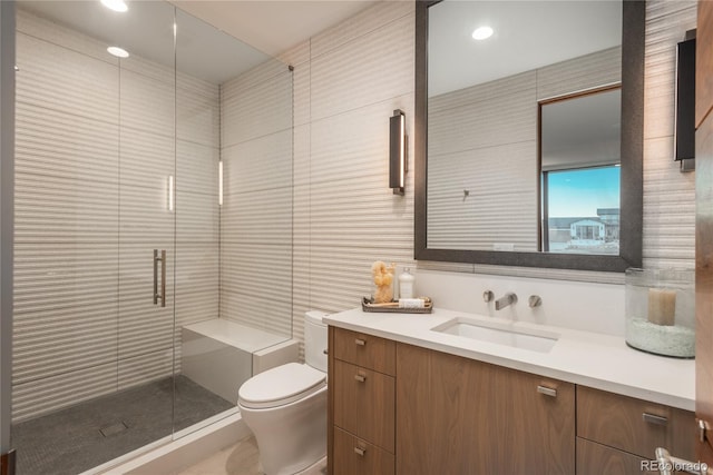 bathroom featuring vanity, recessed lighting, a stall shower, and toilet