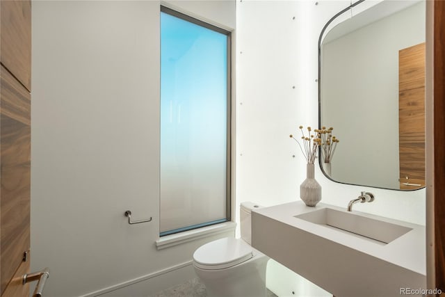 bathroom with toilet and a sink