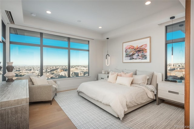 bedroom with recessed lighting, baseboards, and light wood finished floors