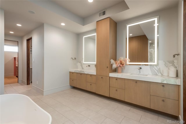 full bathroom with vanity, visible vents, recessed lighting, a soaking tub, and backsplash