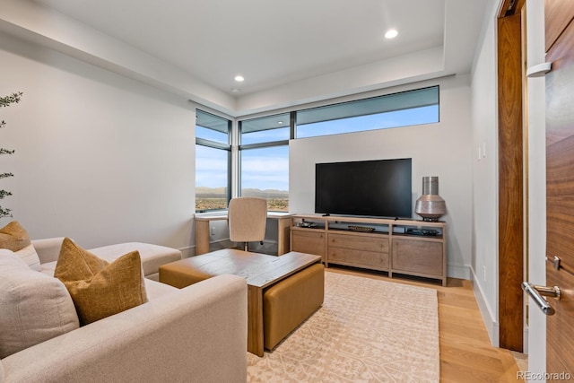 living area with recessed lighting and light wood-style flooring