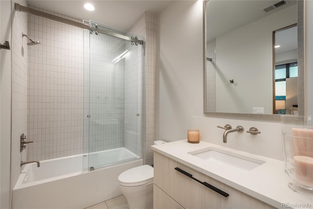full bathroom featuring visible vents, tile patterned flooring, vanity, shower / bath combination with glass door, and toilet