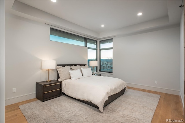 bedroom featuring recessed lighting, baseboards, and light wood-type flooring