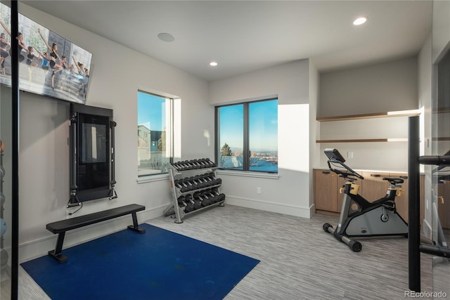 exercise room with recessed lighting, carpet, and baseboards