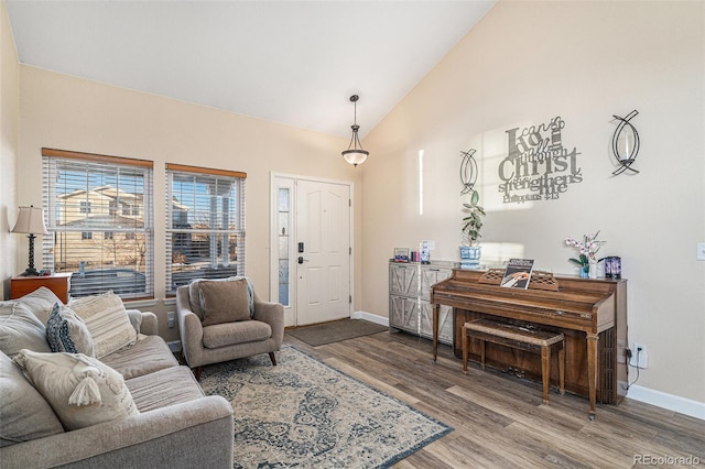 living room with hardwood / wood-style floors and vaulted ceiling