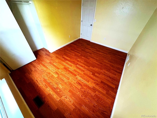 55619 E 31st Ave, Strasburg, CO 80136 - unfurnished bedroom with wood finished floors and baseboards