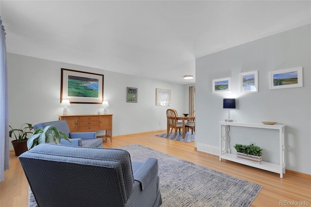 living room featuring light wood-style floors and baseboards