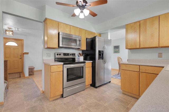 kitchen with ceiling fan, light countertops, and stainless steel appliances