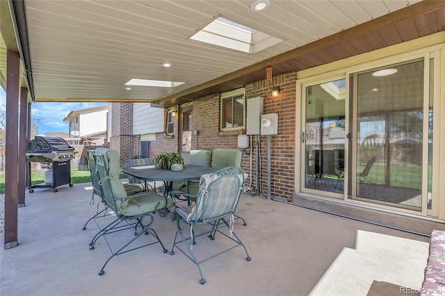 view of patio with outdoor dining space and grilling area