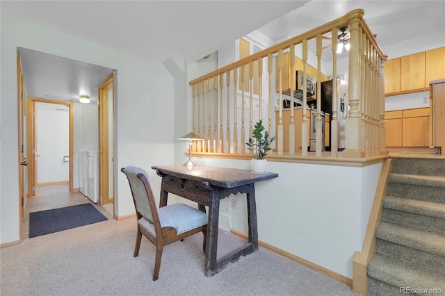 interior space with light carpet and baseboards