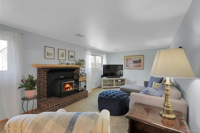 living area with visible vents, baseboards, carpet, and a fireplace