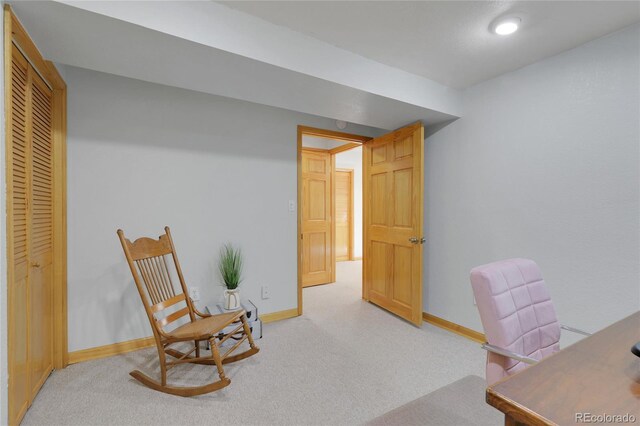 office with baseboards and light colored carpet