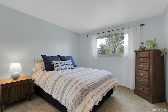 bedroom with baseboards and light colored carpet