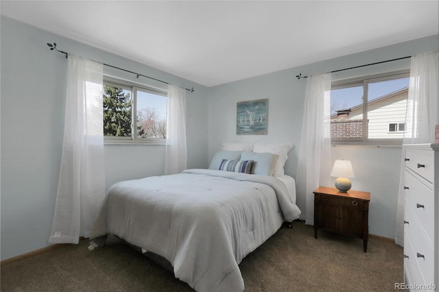 carpeted bedroom featuring baseboards