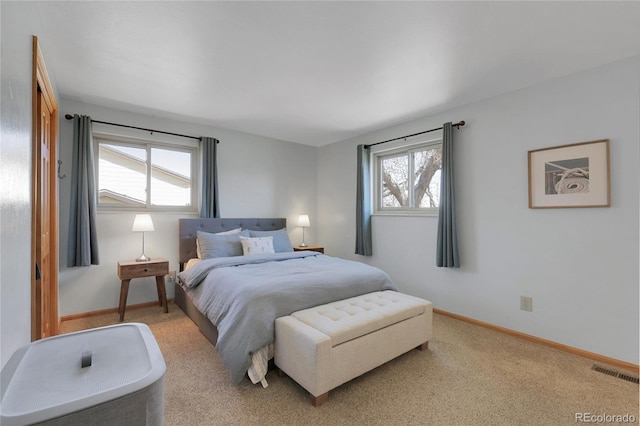 carpeted bedroom featuring visible vents and baseboards