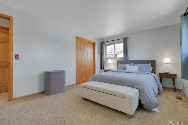 carpeted bedroom featuring a closet and baseboards
