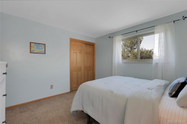 bedroom featuring a closet, carpet, and baseboards