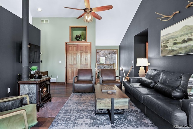 288 Spring Vly, Bailey, CO 80421 - living room with a wood stove, ceiling fan, wood finished floors, and vaulted ceiling