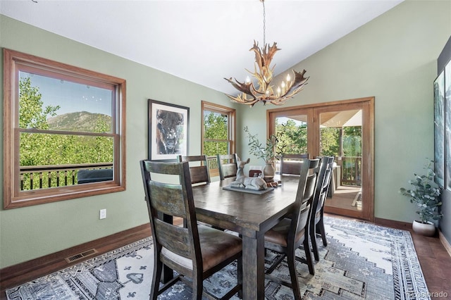 288 Spring Vly, Bailey, CO 80421 - dining room with a chandelier, vaulted ceiling, and wood finished floors