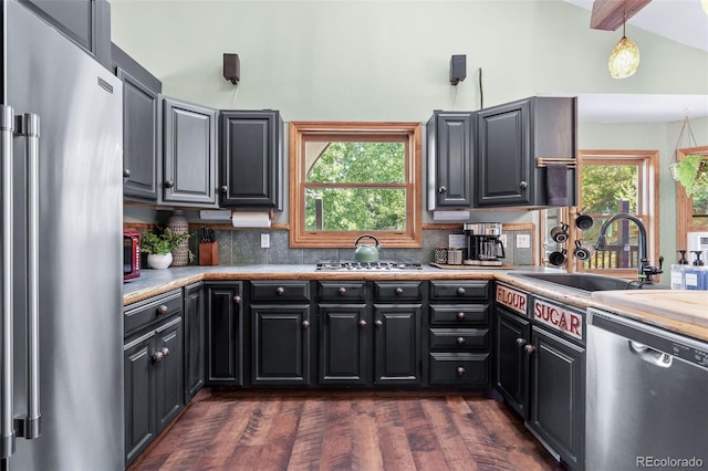 288 Spring Vly, Bailey, CO 80421 - kitchen with stainless steel appliances, light countertops, vaulted ceiling, backsplash, and dark wood finished floors