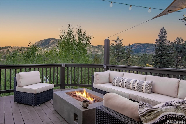 288 Spring Vly, Bailey, CO 80421 - deck at dusk with an outdoor living space with a fire pit and a mountain view